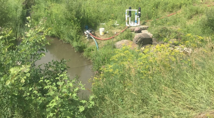 Pump withdrawing water from a small stream in Chittenden County.